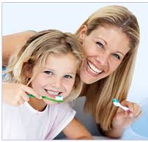 Mother and child brushing teeth together