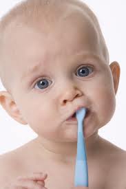 Baby holding a toothbrush
