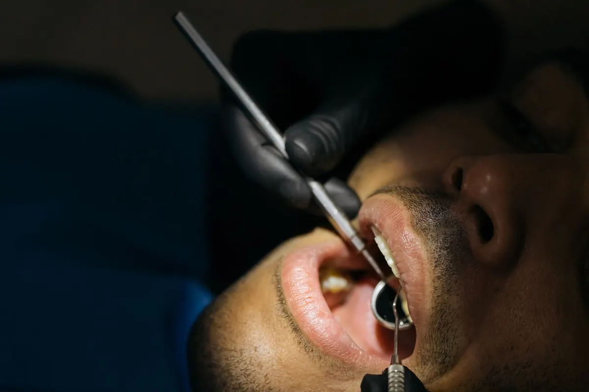 A close-up dental examination with precision instruments